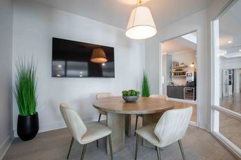 A dining room with a table and chairs
